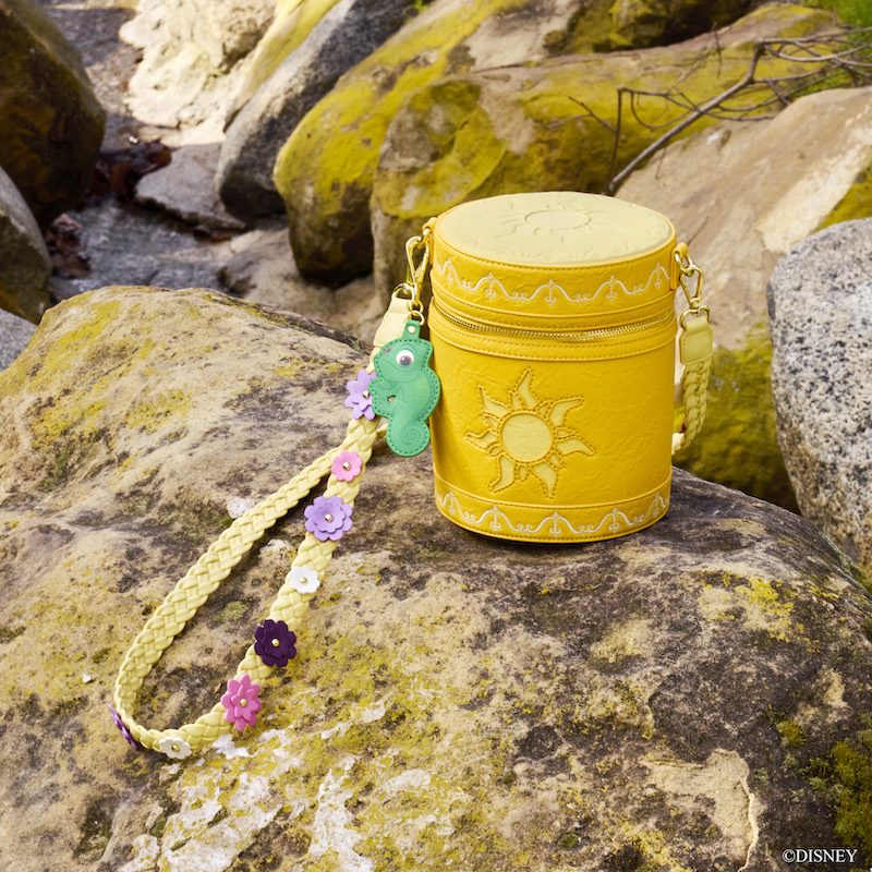 Image of the lantern figural crossbody sitting on a rock outside